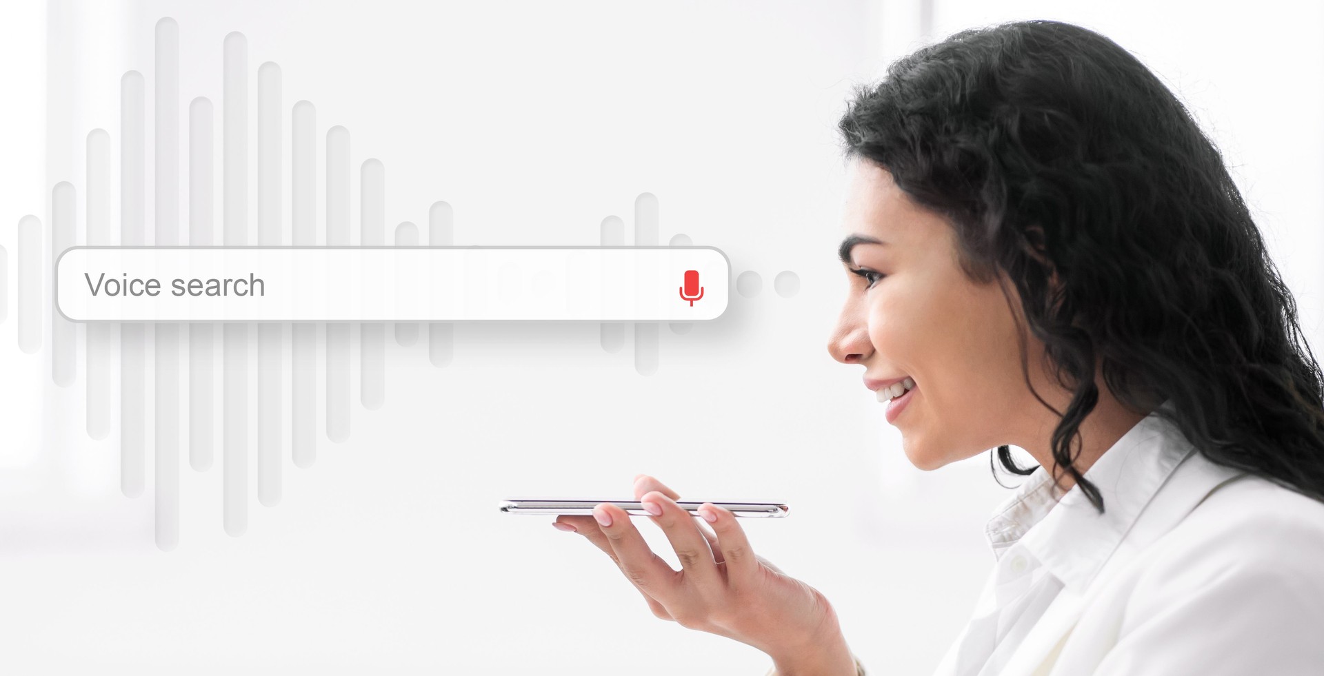 Businesswoman Using Voice Search On Mobile Phone, White Background, Side-View